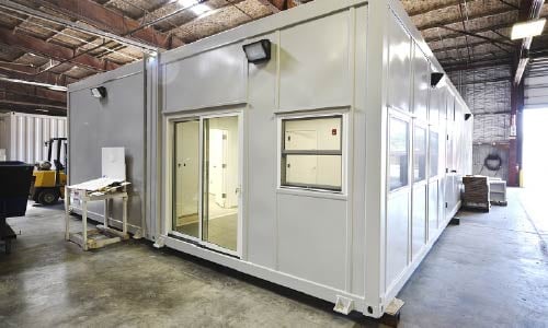 Blast-resistant building inside manufacturing facility prior to delivery to customer site